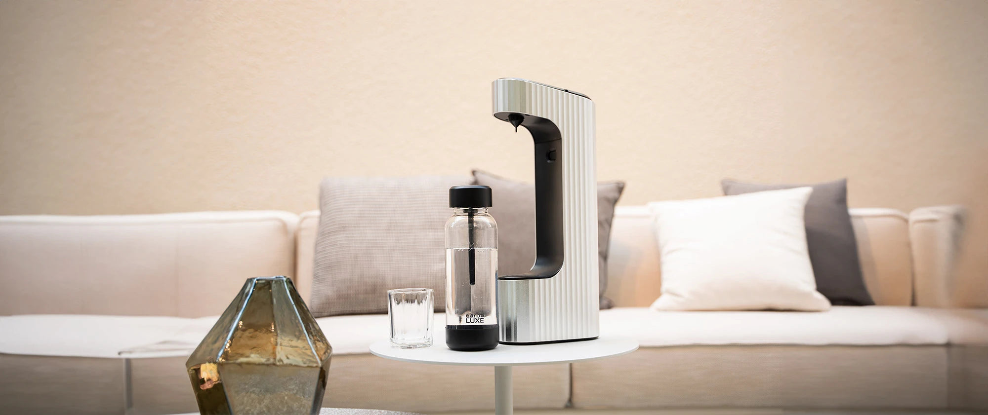 Seleo silver carbonating water machine with PET bottle on a side table in a modern living room setting